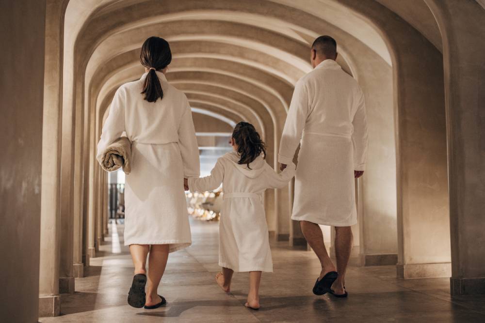 Family wearing bathrobes at luxury hotel