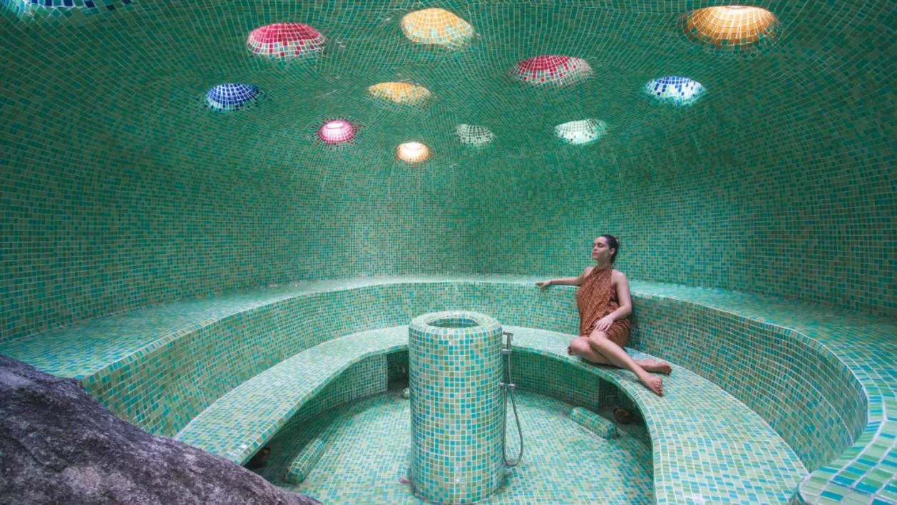 Female guest in steam cavern at Kamalaya
