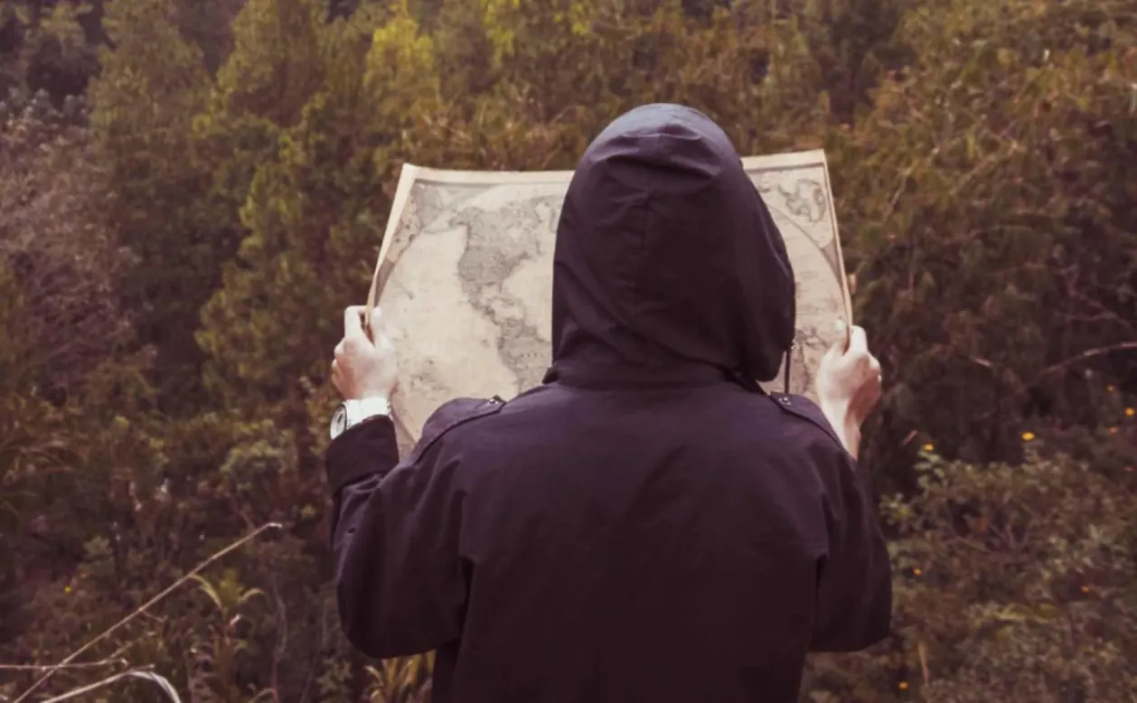 person looking at map on solo trip