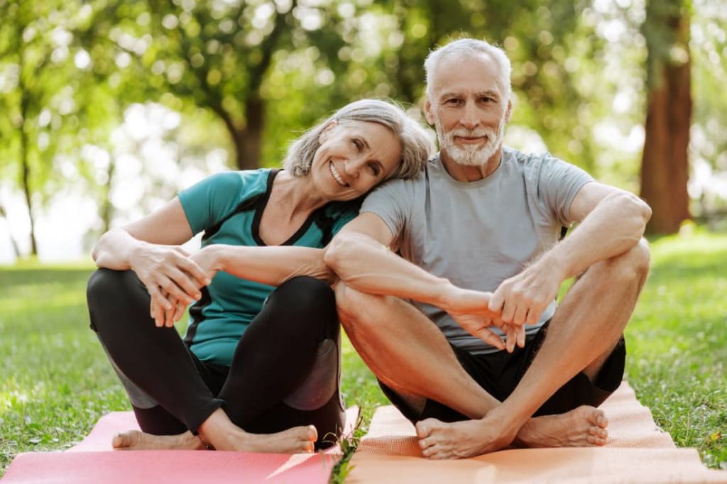 Senior couple relaxing on yoga mat