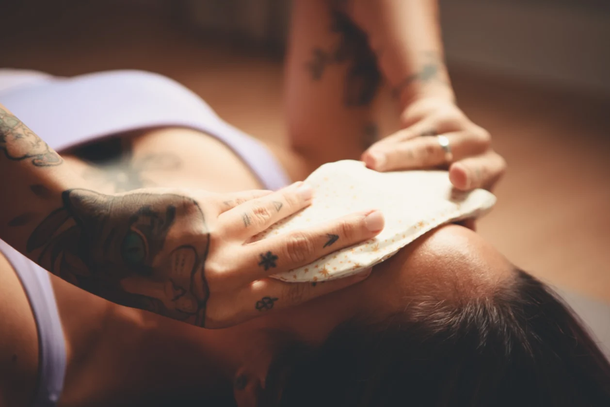 woman relaxing in savasana with eye mask