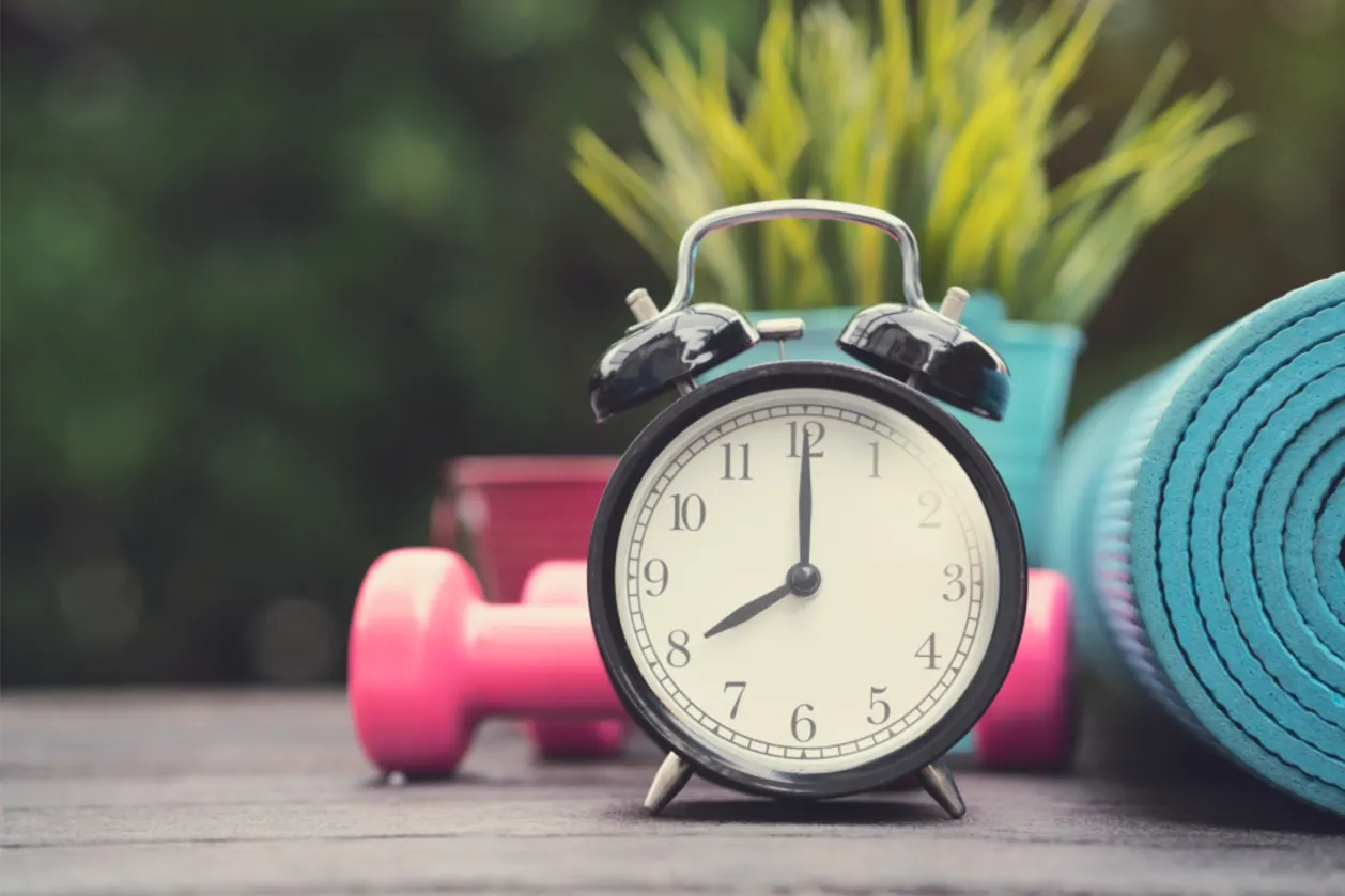 time for exercise clock, yoga mat, dumbbell