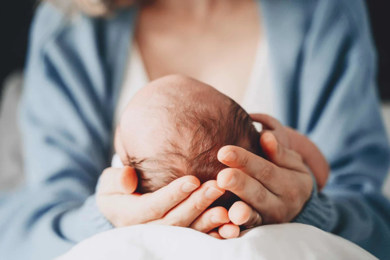 newborn in mother's hands