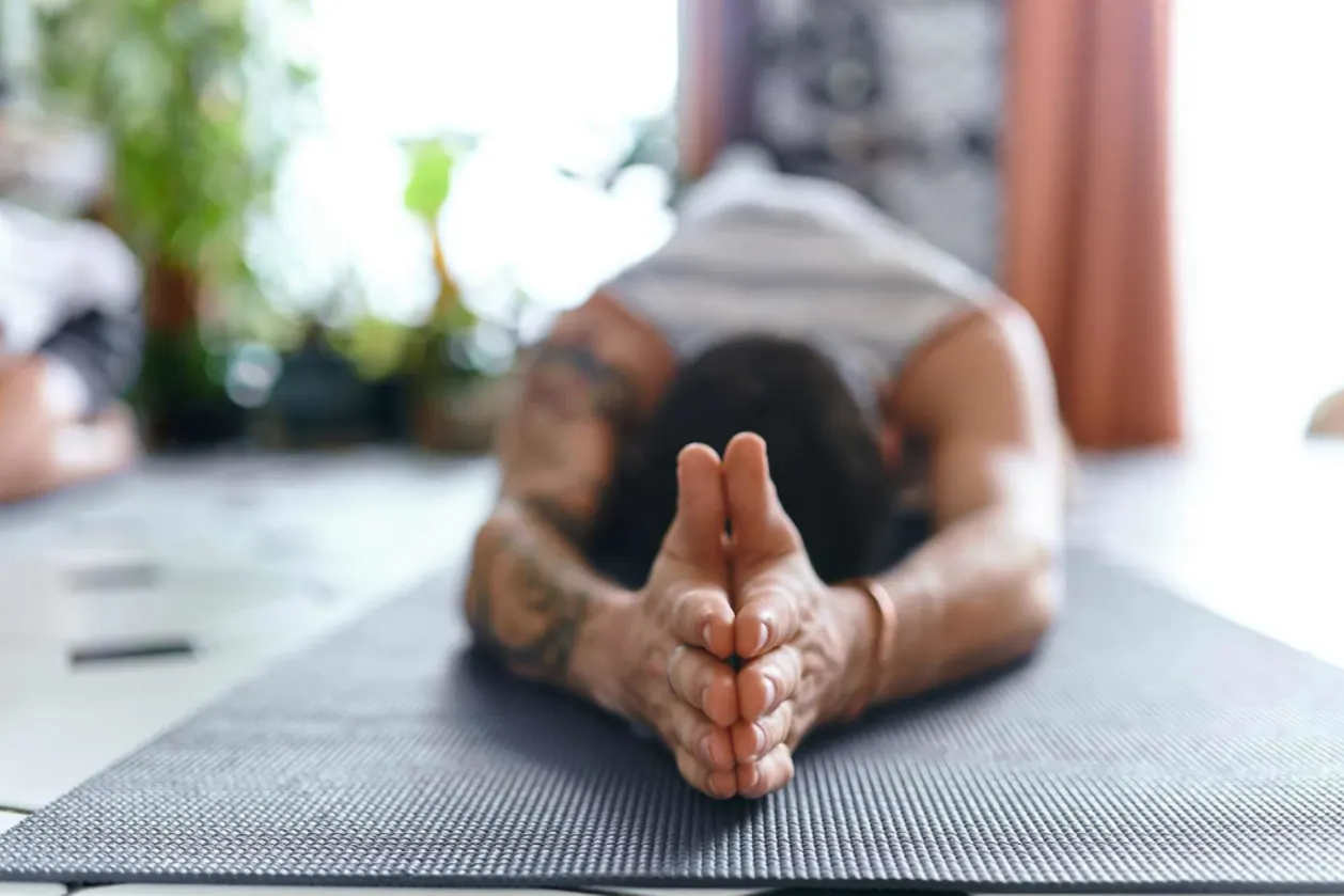 man practicing yoga on travel mat