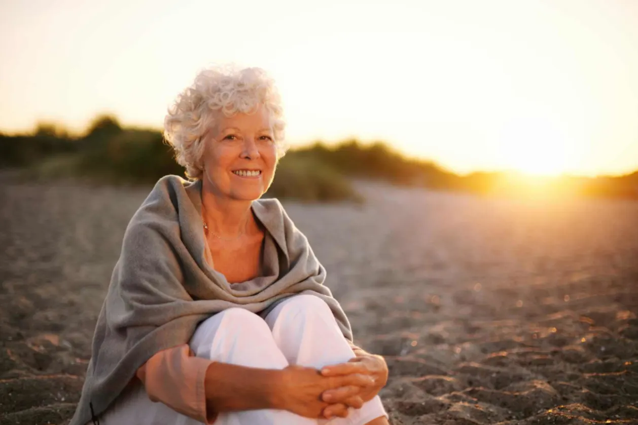 mature woman smiling on beach