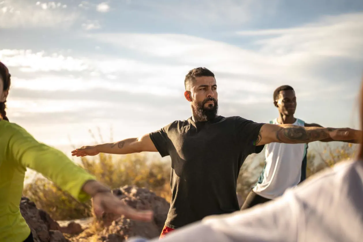 men doing warrior 2 yoga pose