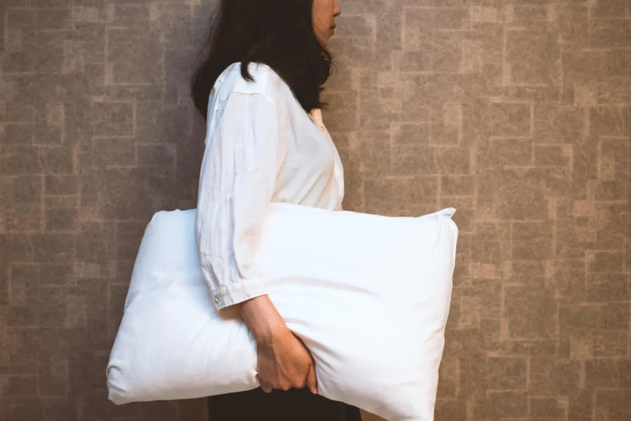 Woman holding a pilow sleep divorce concept