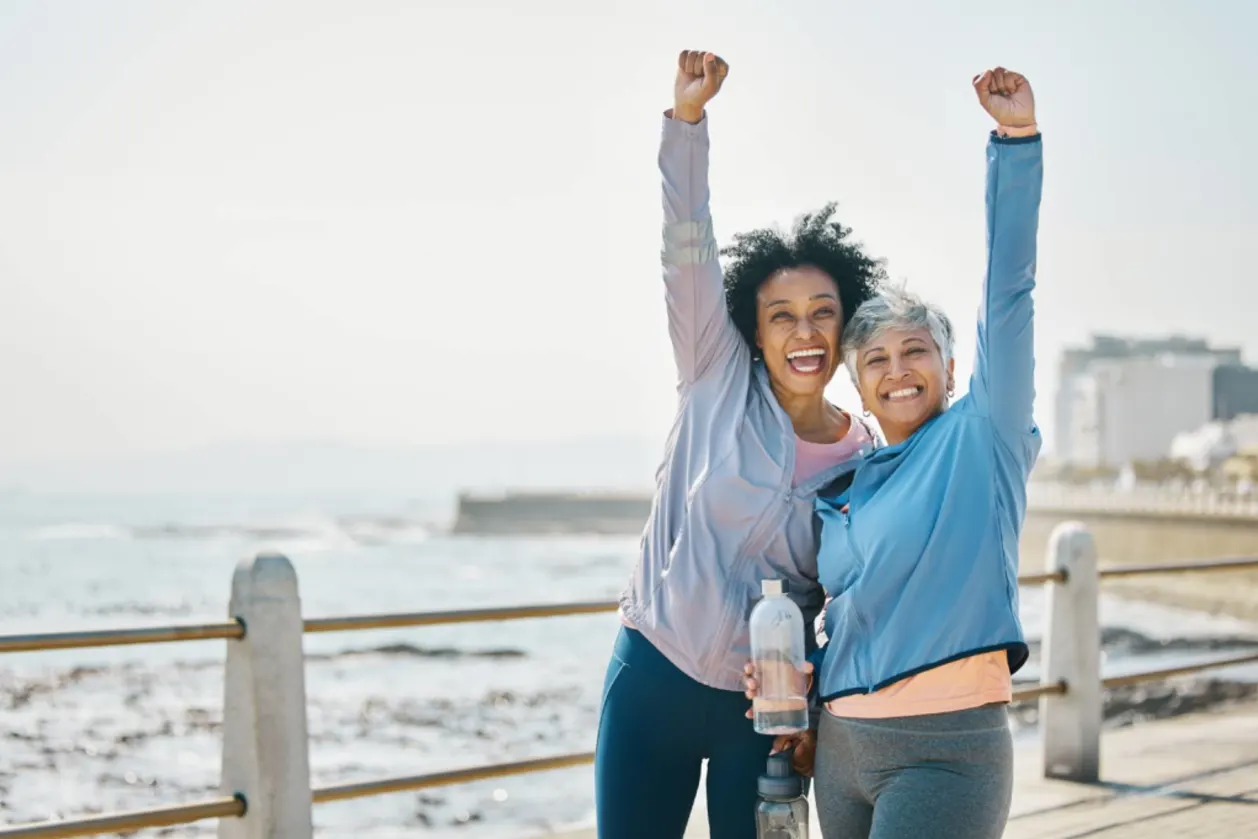 Women and friends, fist pump and fitness goals health span
