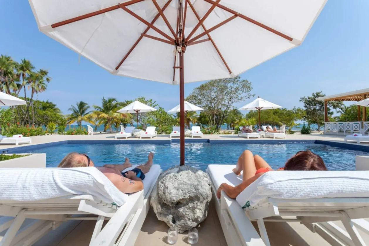 Couple relaxing by pool at Naia Resort & Spa