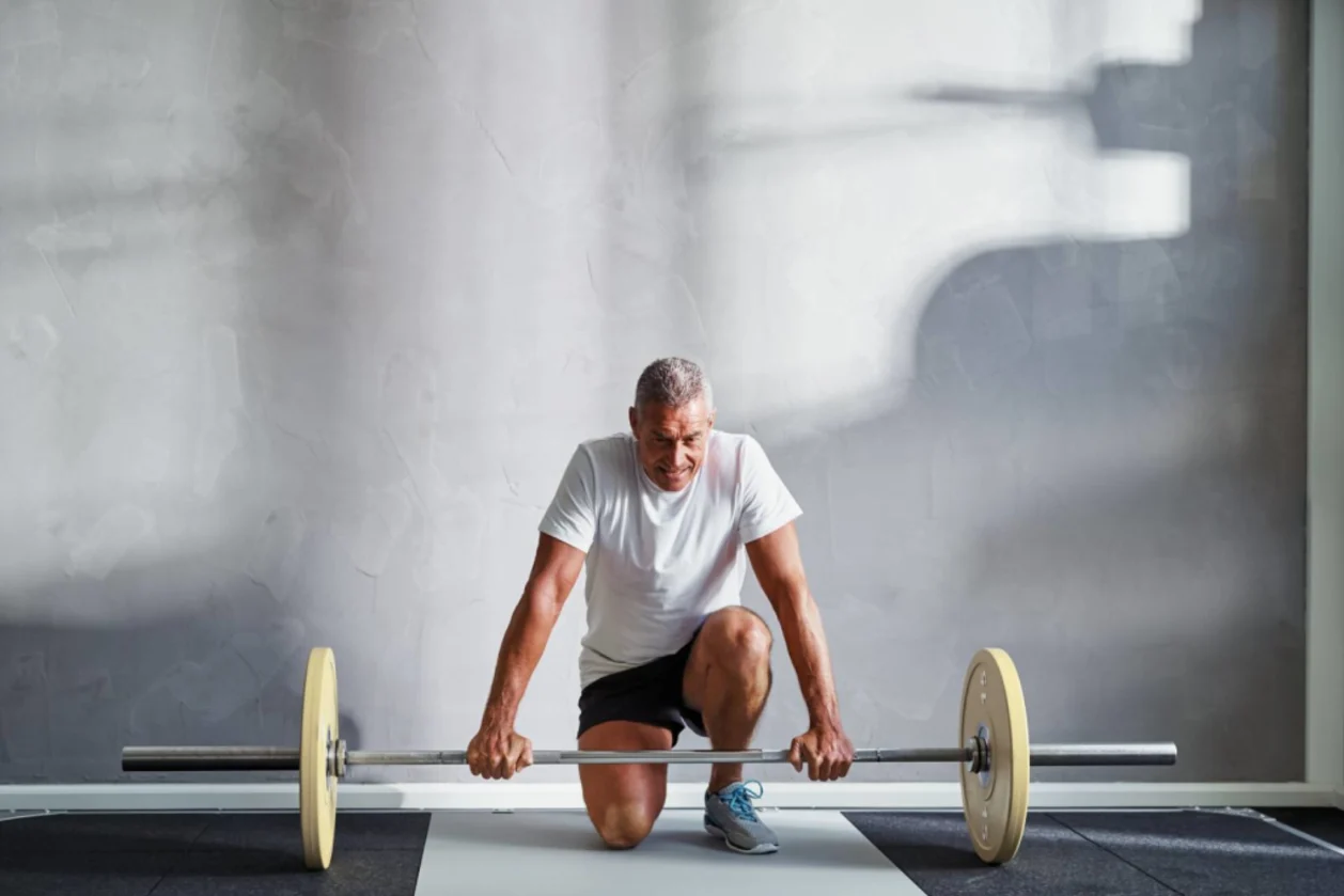 senior man preparing to lift weights benefits of exercise at any age