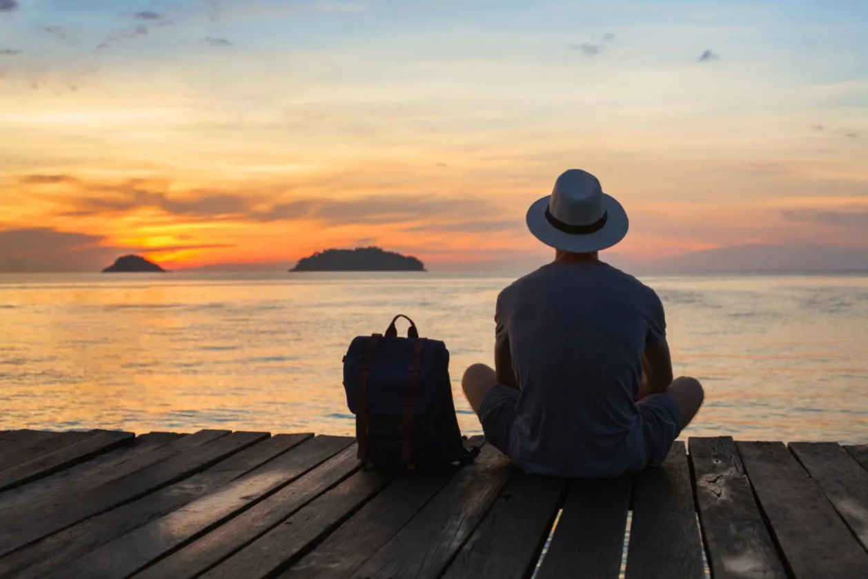 solo male traveler enjoying sunset