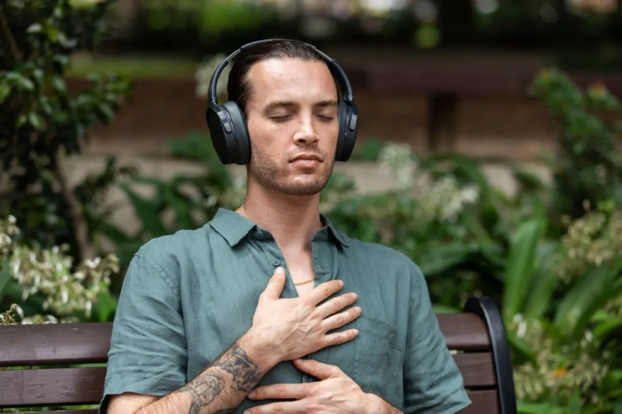 Man with headphones micro-meditating on bench