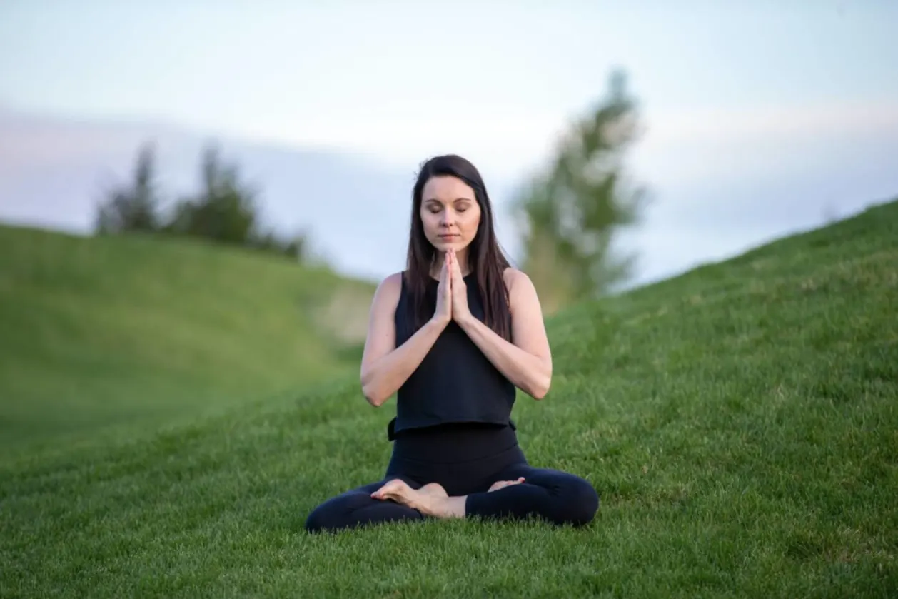 woman meditating outdoors