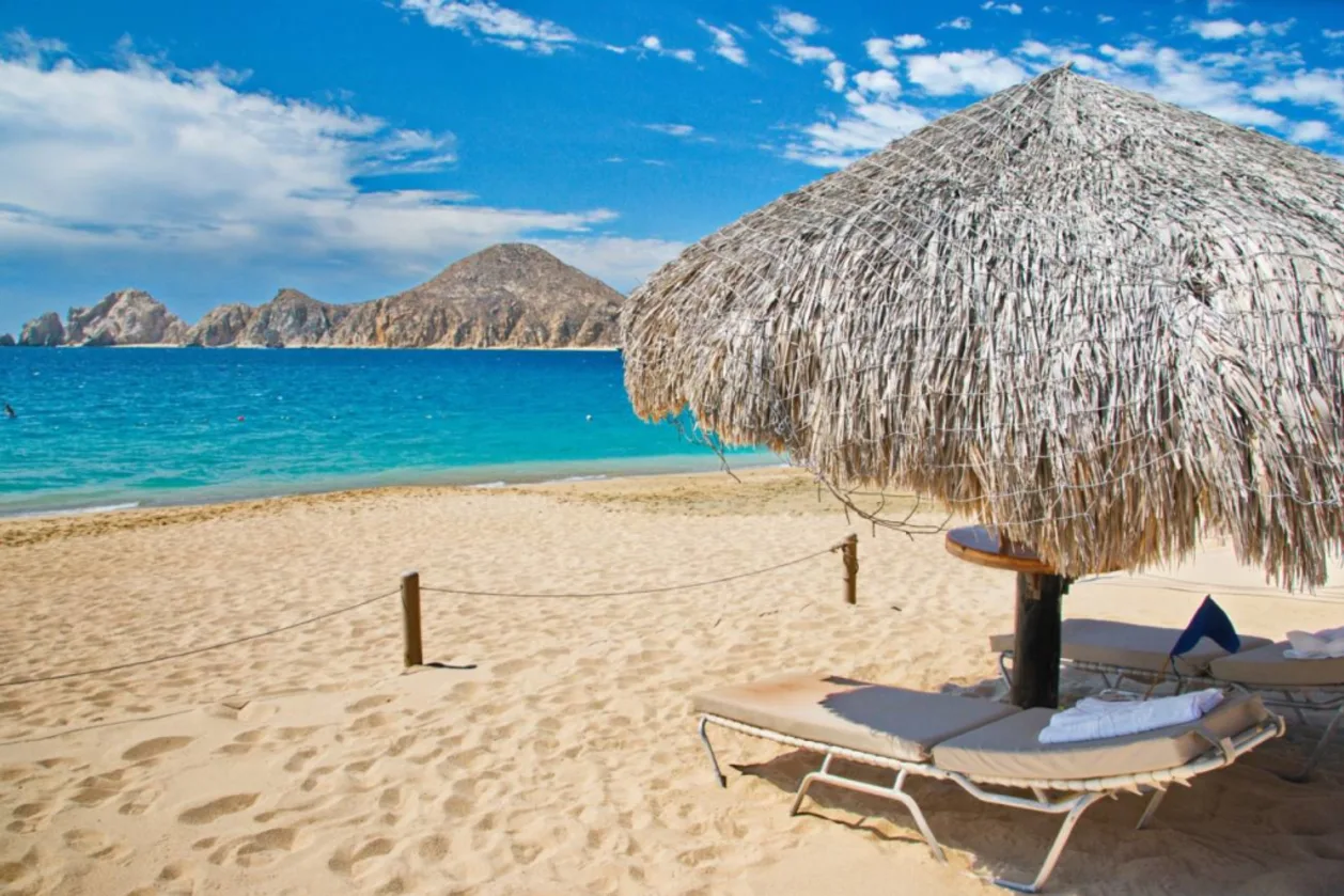 Cabo san lucas beach location with chaise and umbrella