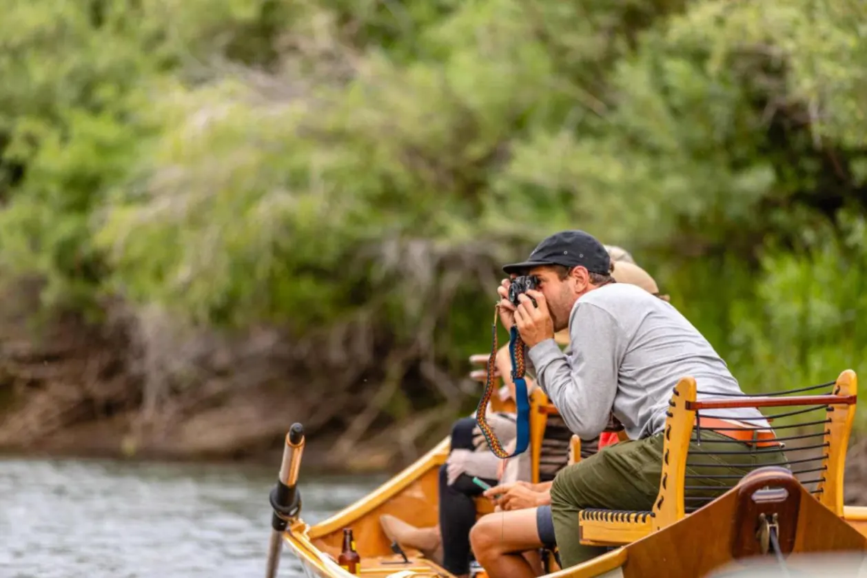 Sage Lodge guests taking photos from boat