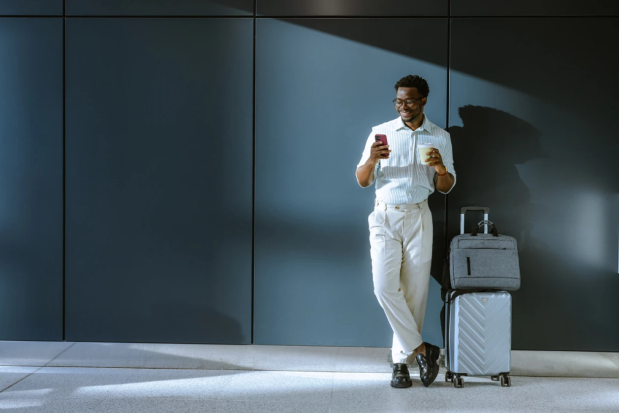 Happy male solo travler with luggage