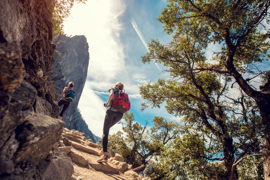 Woman hiking through mountain trail on a sunny day – Jacob Lund