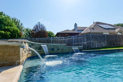 Aerial view of a collaborative design-build family retreat featuring a custom waterfall feature in a Fort Worth, Tarrant County, TX outdoor living space.