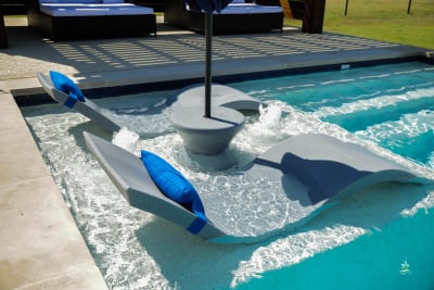 Overhead view of a custom rectangular pool with NPT Blue Seas Royal Blue tile, Buff Lueders coping, and Adobe Buff spray deck in Justin, TX.