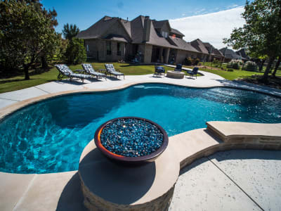 Aerial view of a classic rectangular pool with Peerless Pebble Regatta Blue finish and an 18x18 custom pavilion in a Fort Worth, TX outdoor living space.