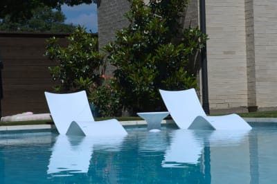 Crystal-clear pool water showcases the pristine tile work and shallow tanning ledge depth at this Champion Residence project in Dallas.