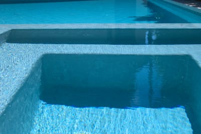 Precision craftsmanship meets luxury design where spa meets pool. This Champion Residence detail showcases expertly installed tile work and seamless coping transitions that define Selah Pools' attention to detail.