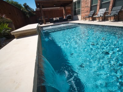 Establishing overview of the Chambers family's complete outdoor environment crafted by Selah Pools in Grand Prairie, Dallas County, TX, where architectural harmony meets refined outdoor living.
