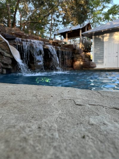 Outdoor swimming pool with multiple water features at the Colon Residence in Santa Rosa Beach, FL.
