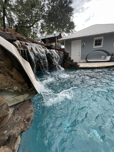 Outdoor swimming pool with spa and water features at the Colon Residence in Santa Rosa Beach, FL.