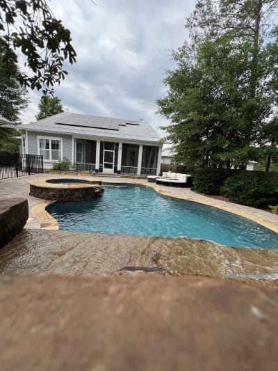 Outdoor swimming pool at the Colon Residence, a luxury backyard retreat in Santa Rosa Beach, FL.