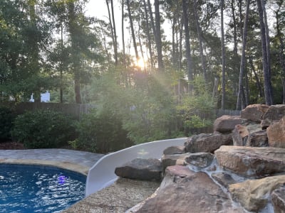 Outdoor pool area at sunset at the Colon Residence, a luxury pool project in Santa Rosa Beach, FL.
