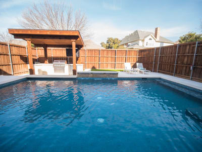 A custom swimming pool taking shape within a connected outdoor living space at the Detillier residence in Irving, Dallas County, TX.
