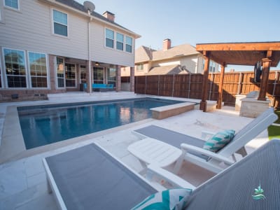 Aerial view of a custom pool and connected patio zones crafted for a family outdoor living space in Irving, Dallas County, TX.