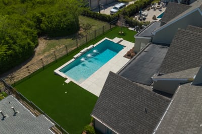 Aerial view of a complete outdoor family retreat at the Chung residence in Fort Worth, Tarrant County, TX, revealing the strategic site planning and natural flow of the finished outdoor living space.