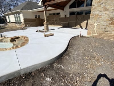 Aerial view of a freeform gunite pool with integrated custom spa, EcoLuxe beach, and composite board walkway in Anna, Collin County, TX.