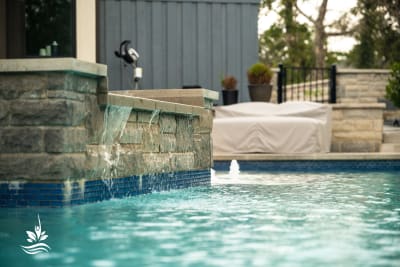 Wide-angle hero view of a 15,160-gallon resort-style pool with NPT Parallax Blue tile, Buff Lueders coping, and integrated custom spa in Flower Mound, TX.