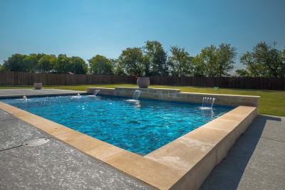Aerial view of a 28-by-16-foot rectangular pool with Pebble Sheen Slate Blue plaster finish and Buff Lueders straight-edge coping in Midlothian, Ellis County, TX.