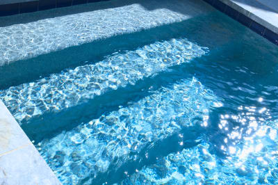 The pristine clarity of properly balanced pool water creates stunning visual depth and reflection, showcasing the meticulous attention to water chemistry that defines every Selah Pools project.