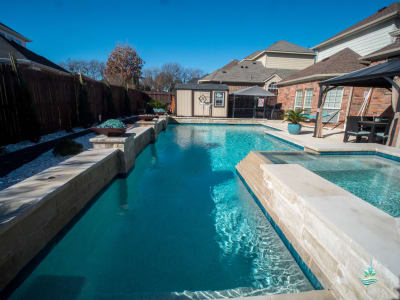 A custom inground spa and pool crafted for multi-generational family connection in a Grand Prairie, Dallas County, TX outdoor living space.