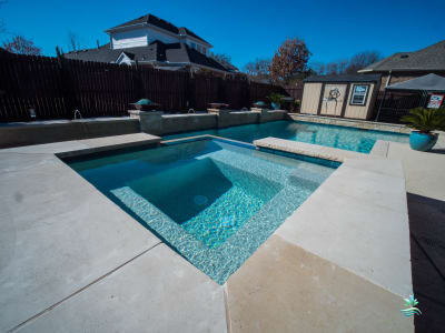 Establishing overview of the Nimo family's complete outdoor living space crafted by Selah Pools in Grand Prairie, Dallas County, TX.
