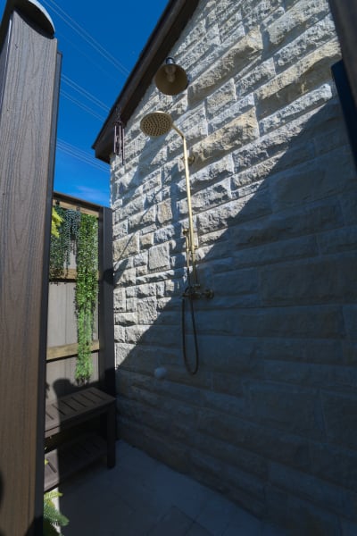 Precision-cut granite coping meets natural stone foundation work at the Olesky Residence, showcasing the meticulous material transitions that define luxury outdoor living environments by Selah Pools.