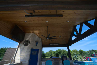Architectural stone pavilion showcasing precision-crafted beam construction and natural stone integration for the ultimate covered outdoor living experience.