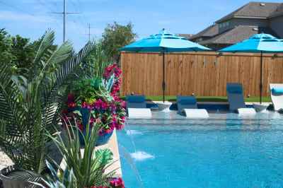 Premium NPT Elysium Peacock 1x2 mosaic tile accents the tanning ledge, creating visual depth against Regatta Blue Pebble finish in this Haslet wellness retreat.