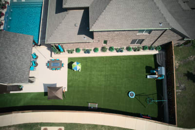 Complete overview of this architectural wellness retreat featuring regatta blue peerless pebble finish and Belgard concrete pavers in French pattern.