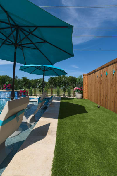 Architectural wellness retreat showcasing the seamless integration of custom pool with covered outdoor living pavilion at the Olesky Residence.