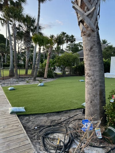 Custom pool and outdoor living space with wooden deck and fireplace at the Sheldon Residence in Miramar Beach, FL.