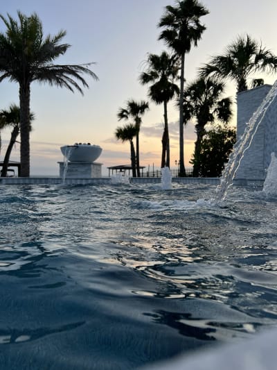 Outdoor swimming pool at sunset in Miramar Beach, FL, showcasing luxury design and refined outdoor living.