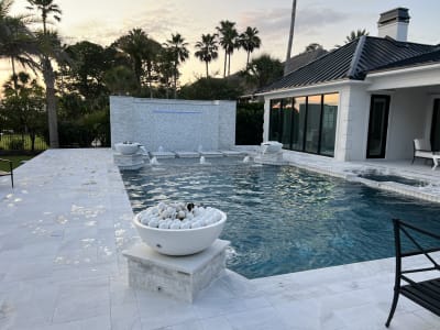 Luxury swimming pool with spa, deck jets, and water feature at the Sheldon Residence in Miramar Beach, FL.