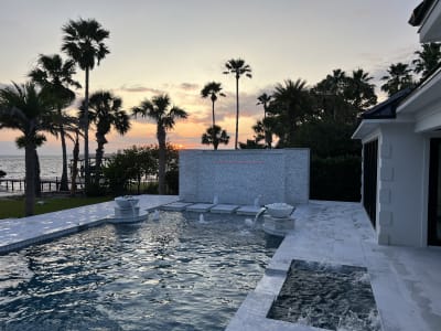 Luxurious swimming pool at the Sheldon Residence in Miramar Beach, FL, photographed at dusk with ambient lighting.