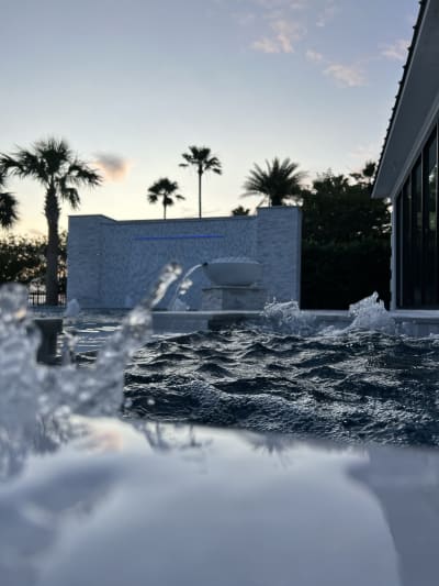 Fountain and water jets with bubblers accent this luxury pool at the Sheldon Residence in Miramar Beach, FL.
